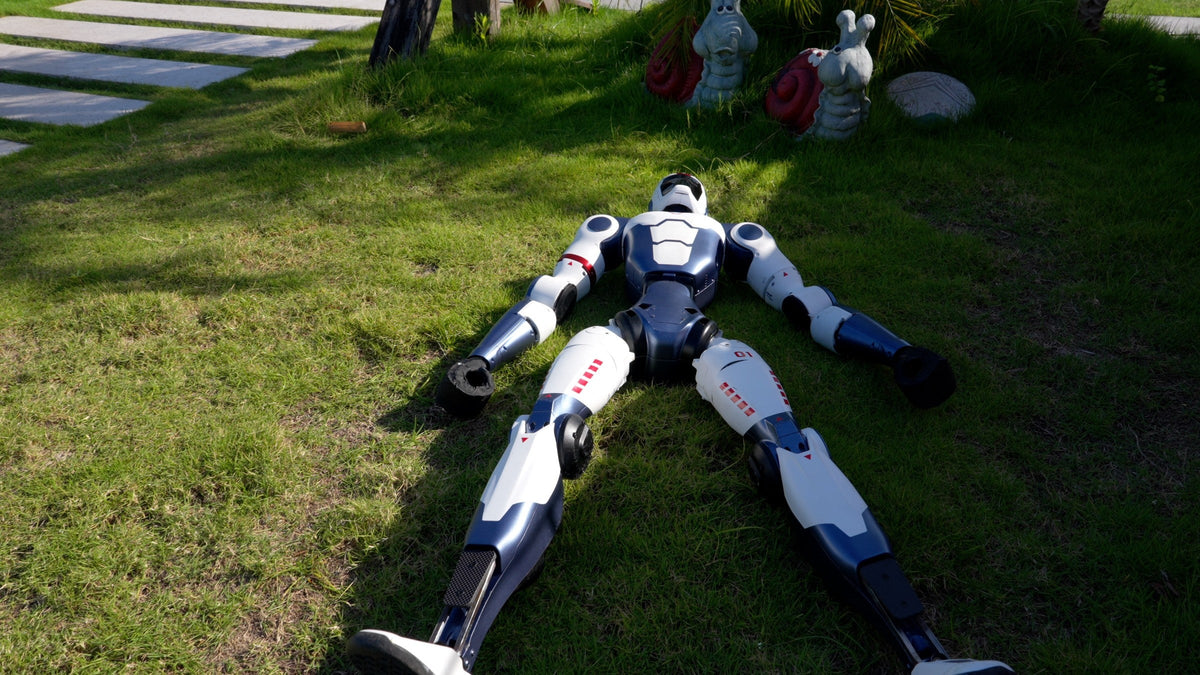 Unitree R1 lying flat before standing up on a remote command